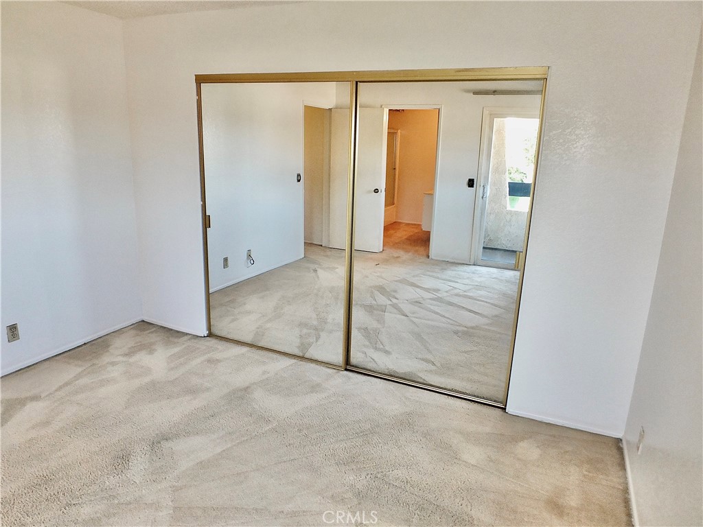 The primary closet is mirrord and deep. - 8485 Kington Way 11, Cypress CA 90630 - photo 22