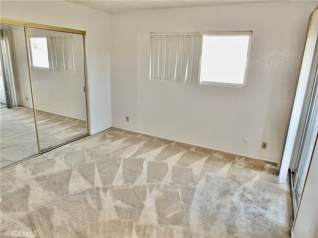 The primary bedroom has abundant light. - 8485 Kington Way 11, Cypress CA 90630 - photo 23