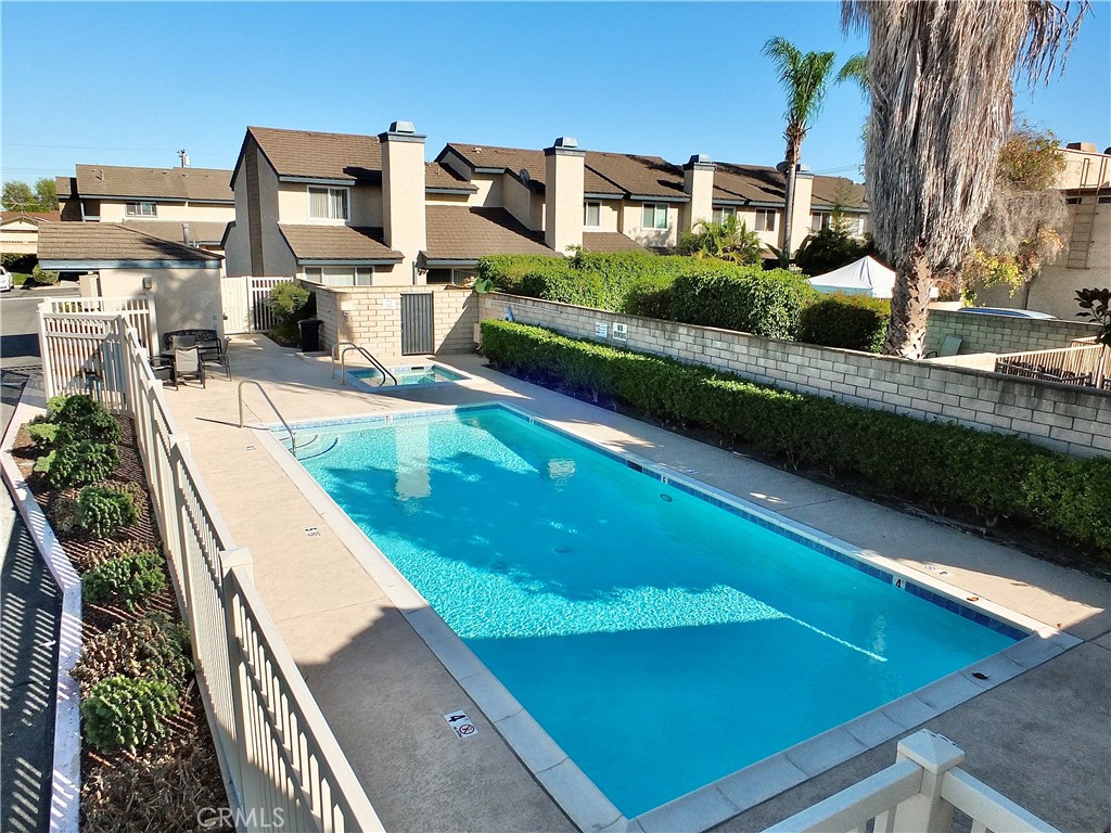The community pool and spa is located at the back of the property. - 8485 Kington Way 11, Cypress CA 90630 - photo 37