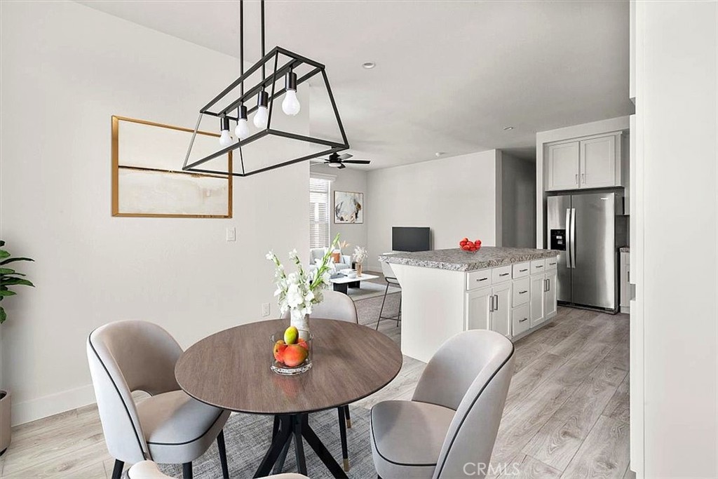 Living Room: Large open living area with updated flooring, recessed lighting, neutral tones, and direct flow to the kitc - 9080 Bloomfield 231, Cypress CA 90630 - photo 8