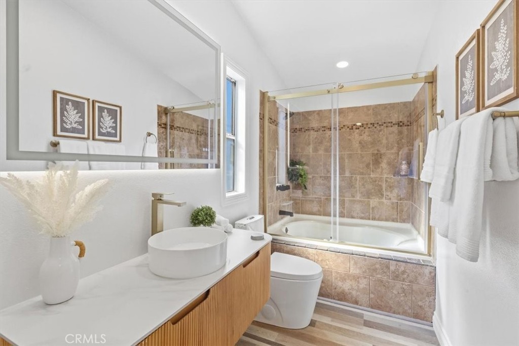 Master Remodeled bathroom with a new vanity, new toilet, fog-free lighted mirror and oversized tub/shower with glass doo - 9080 Bloomfield Avenue 153, Cypress CA 90630 - photo 10