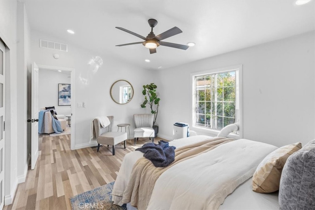 Master Bedroom with room for a sitting area, ceiling fan and plenty of natural light. - 9080 Bloomfield Avenue 153, Cypress CA 90630 - photo 11