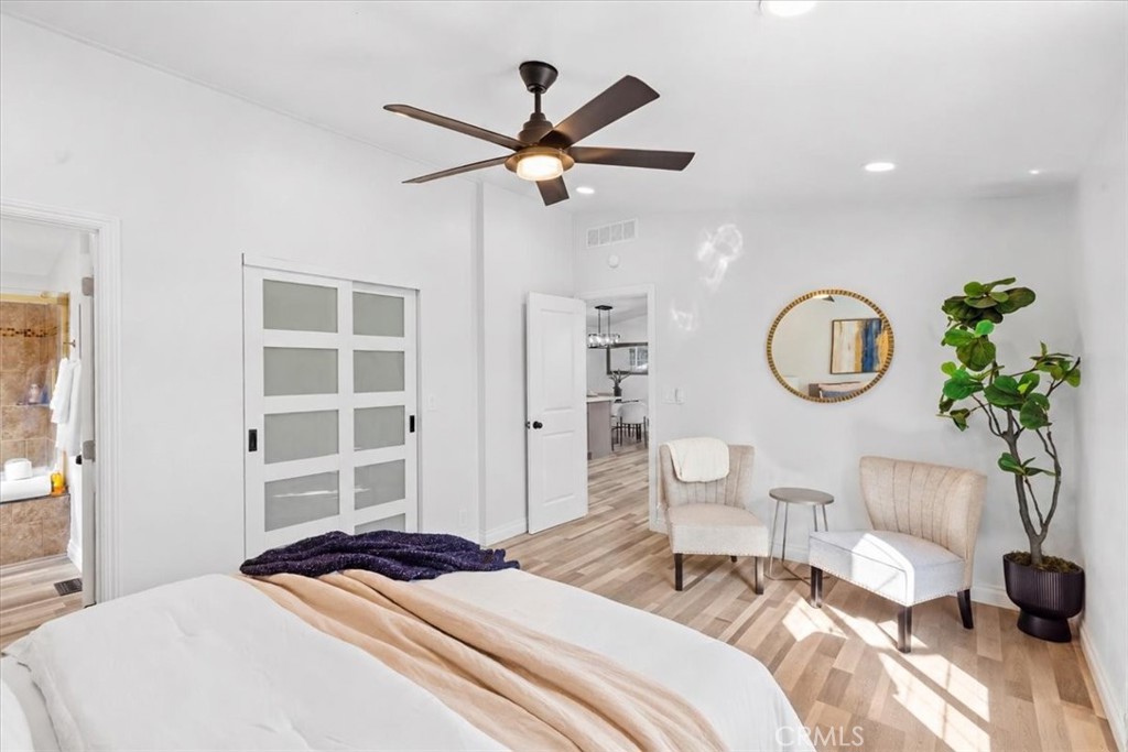 Master Bedroom with space-saving sliding closet doors, ceiling fan and new bedroom door. - 9080 Bloomfield Avenue 153, Cypress CA 90630 - photo 12
