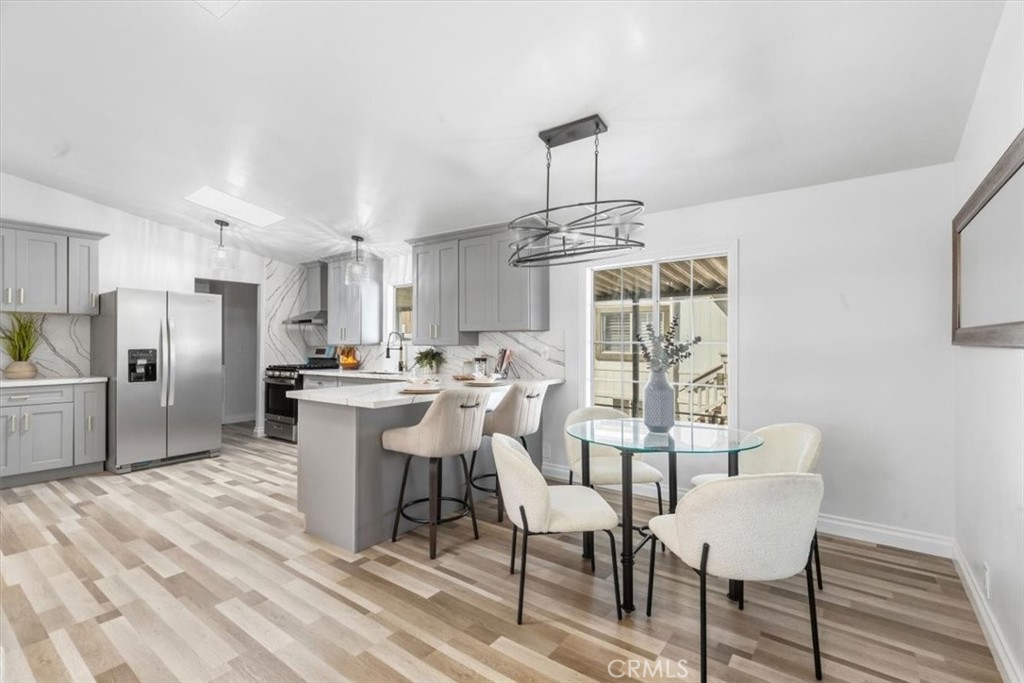 Open dining area next to the kitchen breakfast bar, great for everyday meals and entertaining. - 9080 Bloomfield Avenue 153, Cypress CA 90630 - photo 6