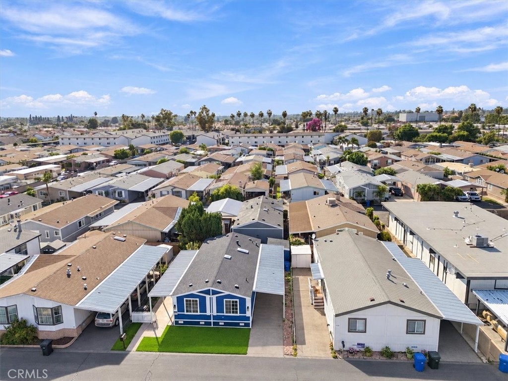 Aerial view of the home in Lincoln Center Mobile Estates, showing the new roof and turf front yard. - 9080 Bloomfield Avenue 153, Cypress CA 90630 - photo 17