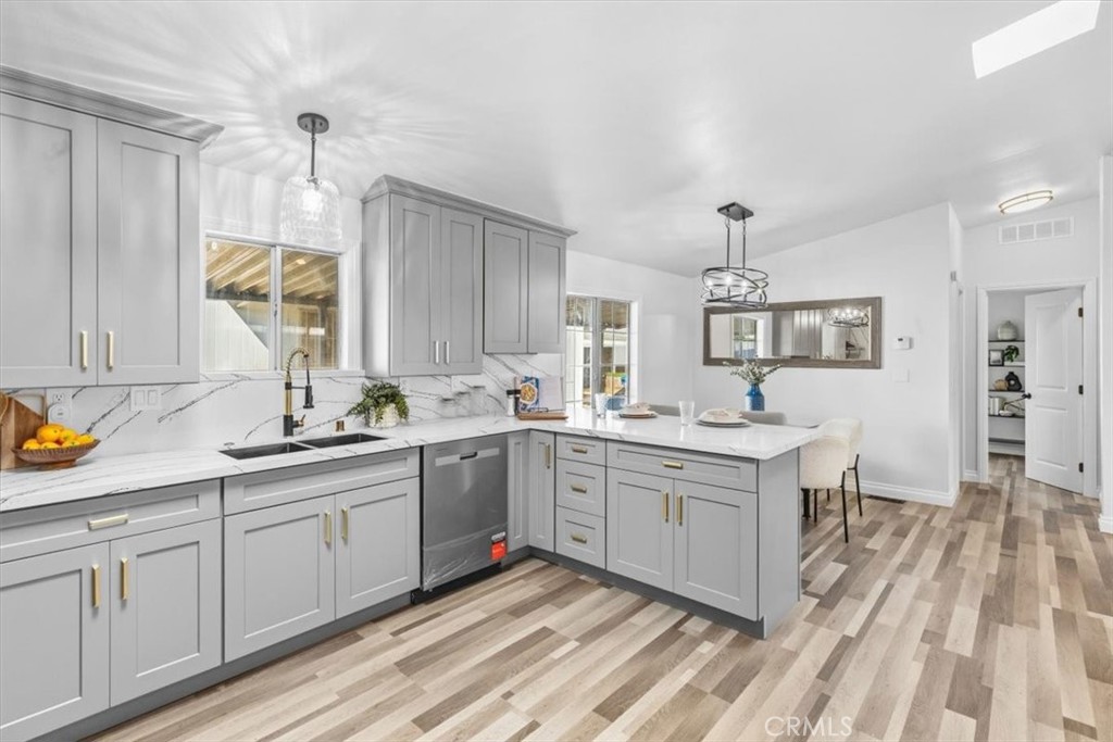 New kitchen sink and faucet, quartz, cabinets counters, stainless dishwasher and pendant lighting. - 9080 Bloomfield Avenue 153, Cypress CA 90630 - photo 4