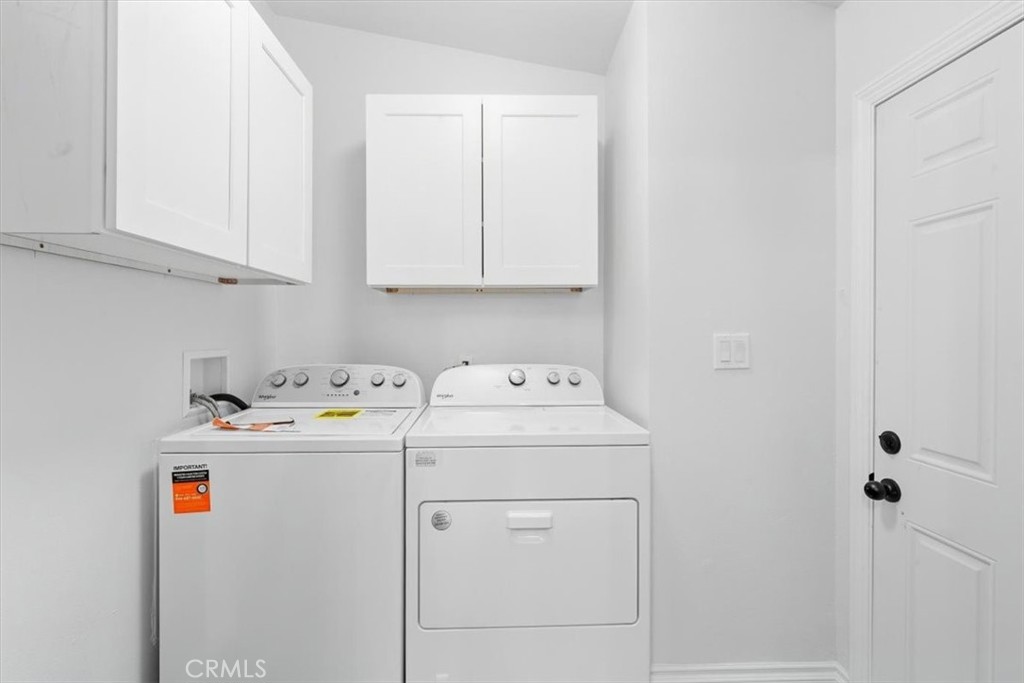 Laundry area with new washer and dryer included, plus storage cabinets. - 9080 Bloomfield Avenue 153, Cypress CA 90630 - photo 16