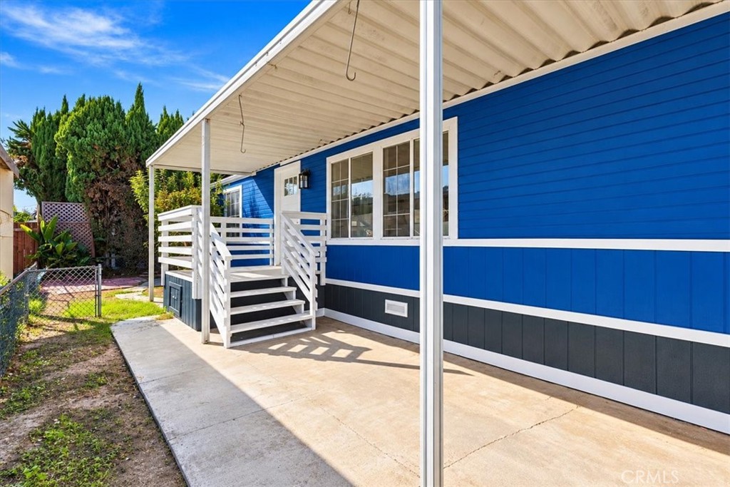 Covered side area with new wood steps, ideal for outdoor patio dining - 9080 Bloomfield Avenue 153, Cypress CA 90630 - photo 19