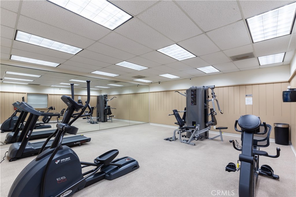 Fitness center with treadmills, an elliptical, an exercise bike and a weight machine. - 9080 Bloomfield Avenue 153, Cypress CA 90630 - photo 26