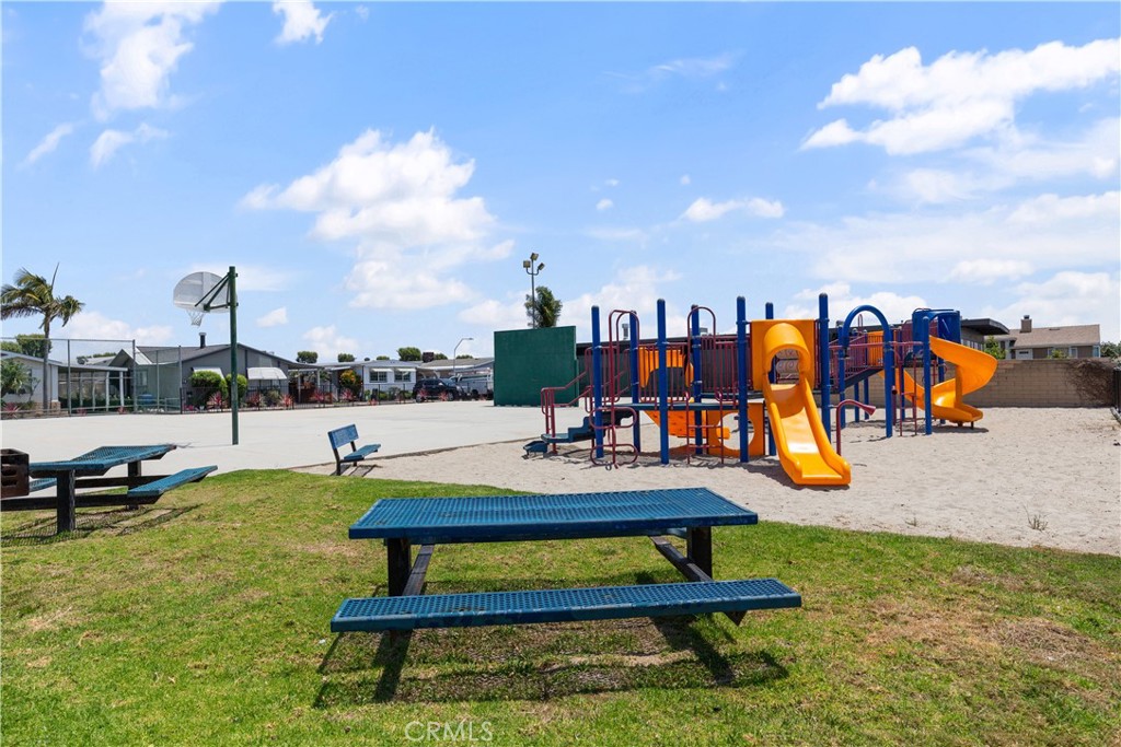 Children’s playground with grassy picnic area and tables. - 9080 Bloomfield Avenue 153, Cypress CA 90630 - photo 27