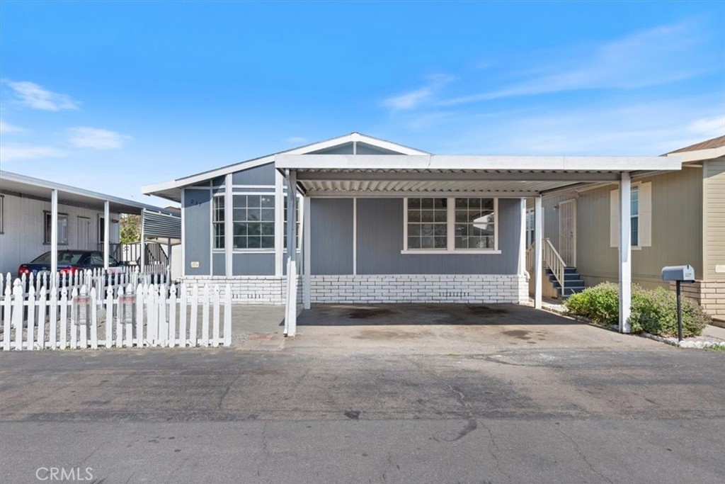 Front “Curb Appeal Meets Comfort — A Spacious Home with Endless Potential!” Description: Charming exterior with side-by- - 9080 Bloomfield Avenue 237, Cypress CA 90630 - photo 1