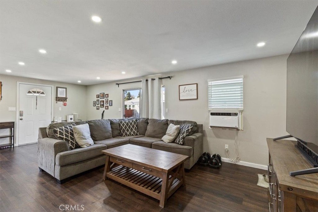 Living Room: Large open living area with updated flooring, recessed lighting, neutral tones, and direct flow to the kitc - 9080 Bloomfield Avenue 293, Cypress CA 90630 - photo 8