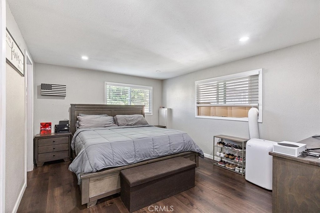 Primary Bedroom: Spacious primary suite with updated flooring, recessed lighting, walk-in closet, and private en suite b - 9080 Bloomfield Avenue 293, Cypress CA 90630 - photo 11
