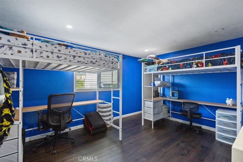 Spacious secondary bedroom with updated flooring, recessed lighting, neutral finishes, and flexible space for sleeping, - 9080 Bloomfield Avenue 293, Cypress CA 90630 - photo 18