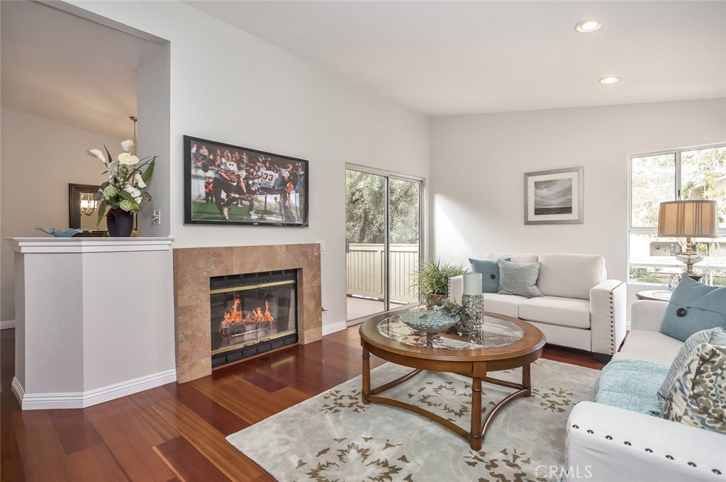 Wonderful Living Room with fireplace, vaulted ceiling, recessed lighting and access to a large patio - 16 Corniche Drive E, Dana Point CA 92629 - photo 1