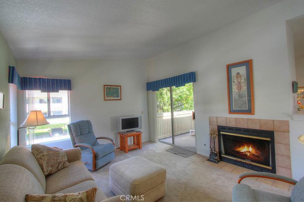 Sunny living room, wrap around balcony to bedroom. Gas/wood fireplace. High Ceilings - 18 CORNICHE Drive H, Dana Point CA 92629 - photo 1
