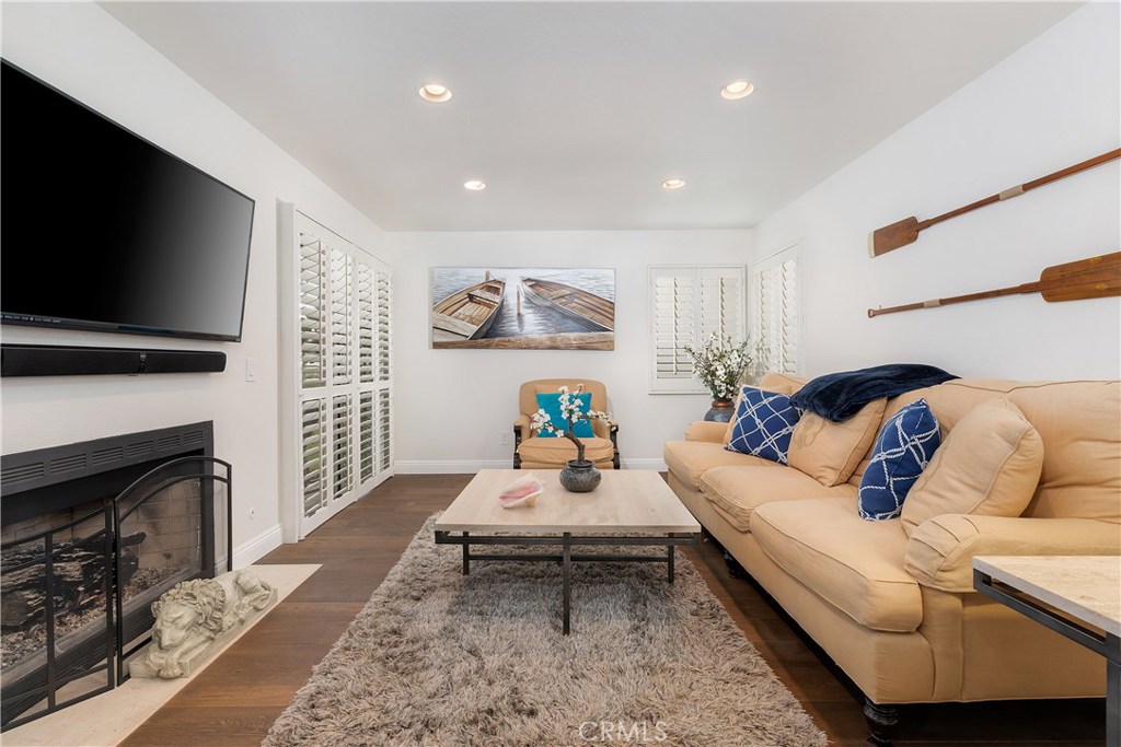 Living room with fireplace and TV - 20 Corniche Drive C, Dana Point CA 92629 - photo 1