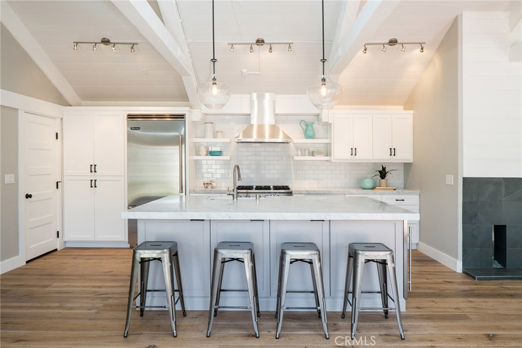 Oversized island with custom cabinets throughout the kitchen and marble countertops. - 23682 Sidney Bay, Dana Point CA 92629 - photo 1