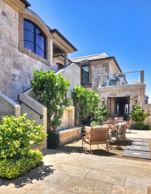 The entry courtyard with fire element and fountain sets the tone of a European villa - 23792 Salvador Bay, Dana Point CA 92629 - photo 1
