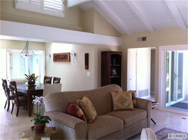 Bright living room & dining room notice the travertine flooring, vaulted ceilings and access to outdoor space from every - 23811 SALVADOR BAY, Dana Point CA 92629 - photo 1