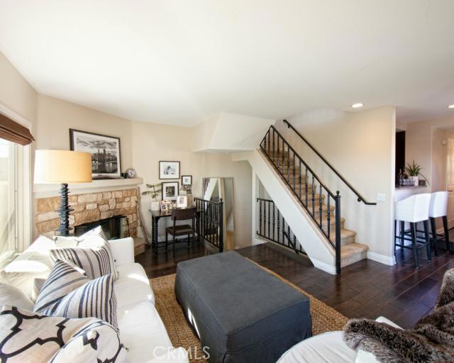 Front facing Ocean View Living Room with cozy Stone faced fireplace and Hardwood flooring. Stairs up to Master Suite and - 24352 Vista Point Lane, Dana Point CA 92629 - photo 1