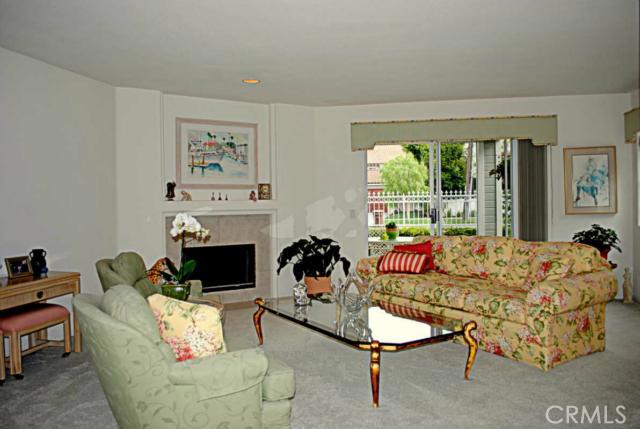 Formal living room with Marble faced fireplace and walk out covered patio. - 24445 Santa Clara Avenue, Dana Point CA 92629 - photo 1