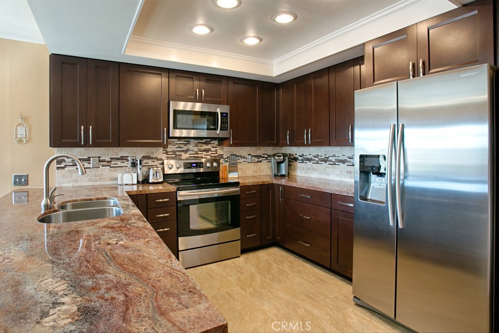 Gorgeous remodeled kitchen with plenty of Granite counter space, custom backsplash, updated cabinets, Stainless steel ap - 24592 Seth Circle, Dana Point CA 92629 - photo 1
