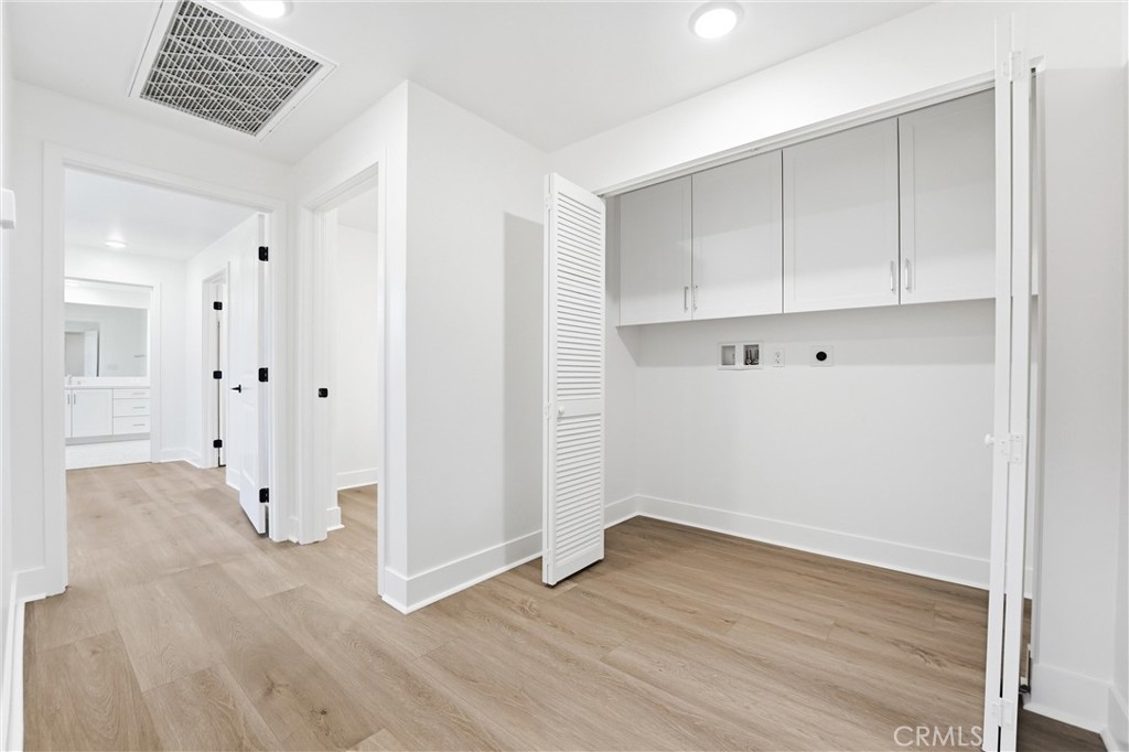Laundry closet and hallway to primary suite - 24722 Del Prado 201, Dana Point CA 92629 - photo 23