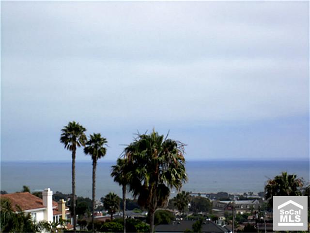 Panoramic Coastal Views are enjoyed from this highly upgraded end unit Harbor close townhome - 24752 SEA SHELL Way, Dana Point CA 92629 - photo 1
