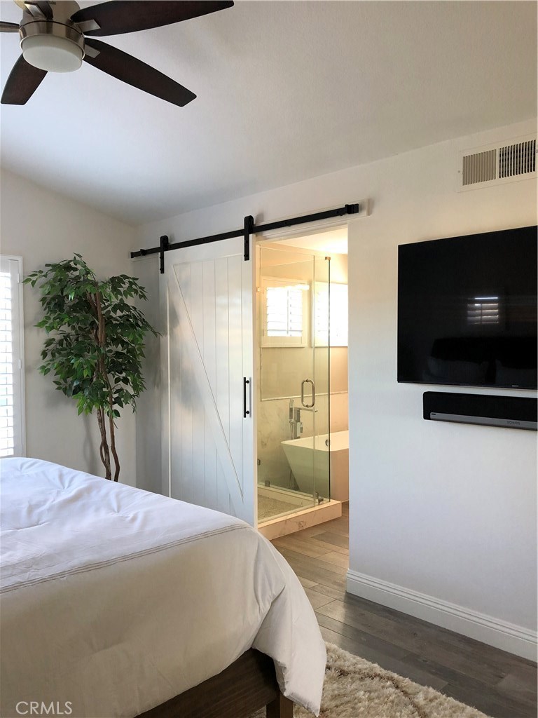 Master bedroom with Barn door open to custom shower, bath and walk in closet with built-ins. - 25 Ville Franche, Dana Point CA 92629 - photo 10