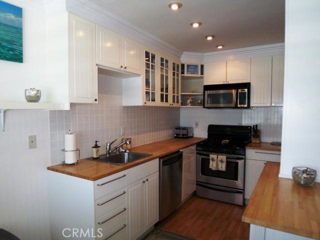 Light & Bright Kitchen Features Newer Cabinetry with Glass Insets - 25034 Terrace Lantern 30, Dana Point CA 92629 - photo 1
