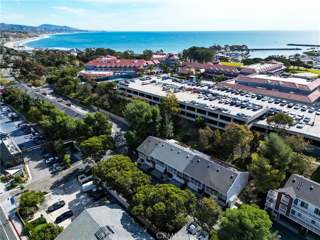 Aerial view of Pacific Terrace community with coastline and harbor in background. - 25072 Terrace Lantern 18, Dana Point CA 92629 - photo 1