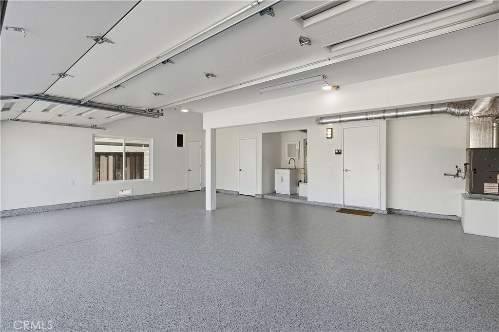 View inside garage with new garage door and epoxy floor. - 25302 Neptune Drive, Dana Point CA 92629 - photo 25