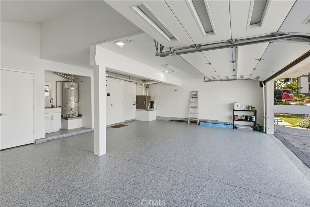 View inside garage with new garage door and epoxy floor. - 25302 Neptune Drive, Dana Point CA 92629 - photo 26