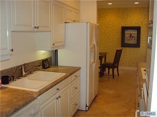 Beautiful kitchen with Granite counter tops and Travertine floors - 25422 SEA BLUFFS Drive 204, Dana Point CA 92629 - photo 1