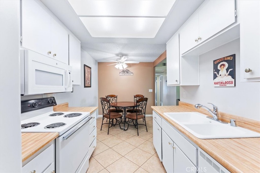 Kitchen has microwave, dishwasher, refrigerator and stove. - 25611 Quail Run 32, Dana Point CA 92629 - photo 8