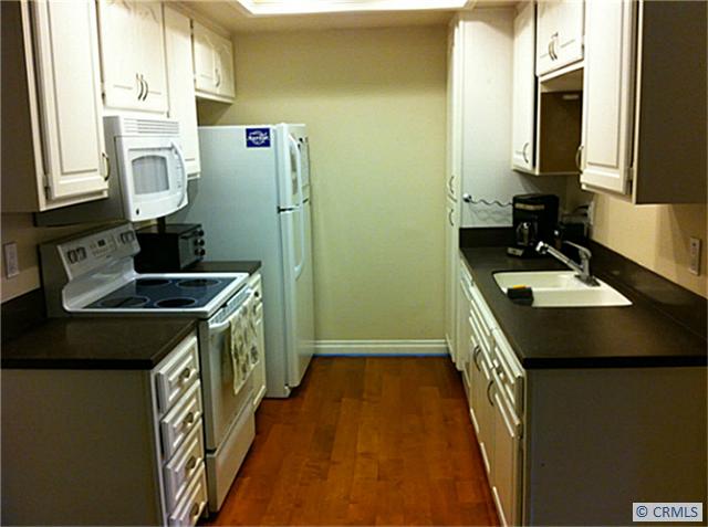 Galley style kitchen with new flooring - 25611 QUAIL Run 92, Dana Point CA 92629 - photo 1