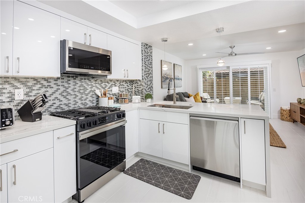 Kitchen with Waterfall Quartz Countertop - 25656 Fishermans Drive 221, Dana Point CA 92629 - photo 7