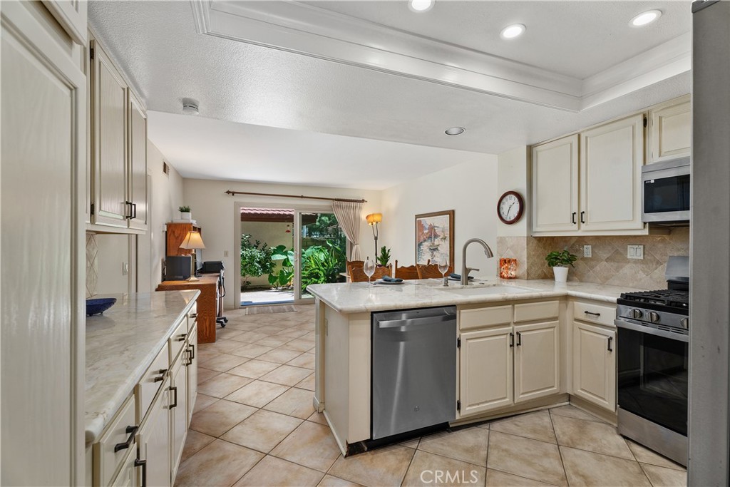 Bright kitchen with tray ceiling and recessed lighting - 25742 Shell Drive 189, Dana Point CA 92629 - photo 5