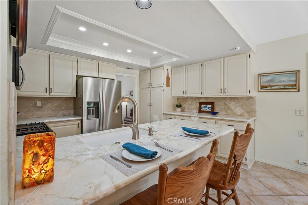 Breakfast bar with stone counters - 25742 Shell Drive 189, Dana Point CA 92629 - photo 16