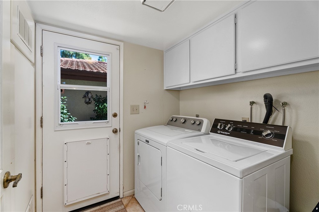 Laundry room with pet door to the courtyard - 25742 Shell Drive 189, Dana Point CA 92629 - photo 22