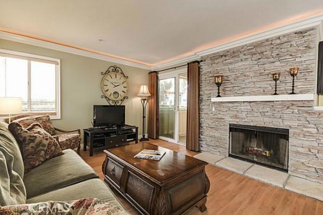 Living Room with Wood Laminate Floors Patio Access and Fire Place (no carpet in the home) - 26 Corniche Drive D, Dana Point CA 92629 - photo 1