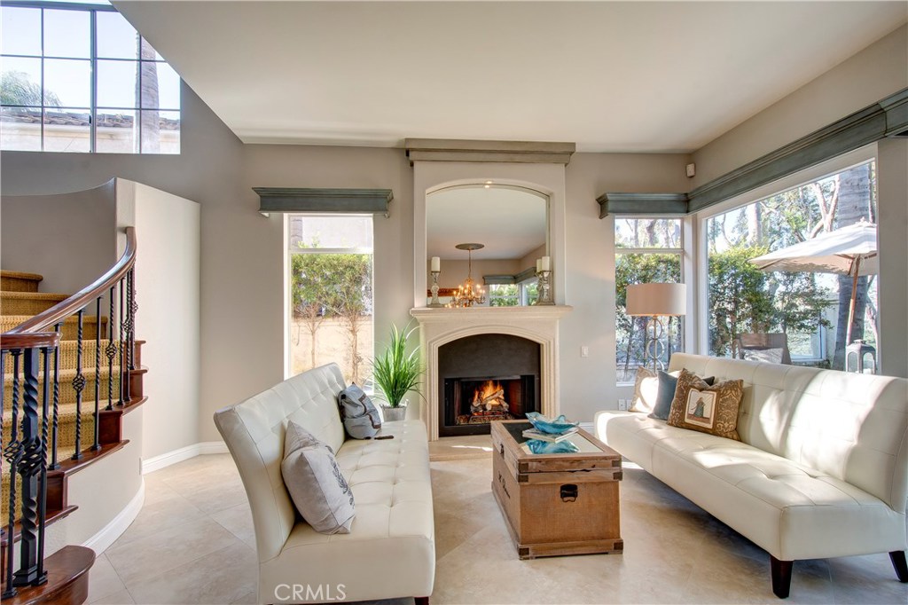 Light and bright elegant living room with cozy fireplace surrounded by windows to let the natural light in - 26 Imperatrice, Dana Point CA 92629 - photo 1