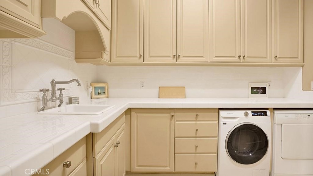 Laundry room. Spacious, with two dryers, lots of storage and countertop space and sink. - 26 RITZ COVE, Dana Point CA 92629 - photo 59
