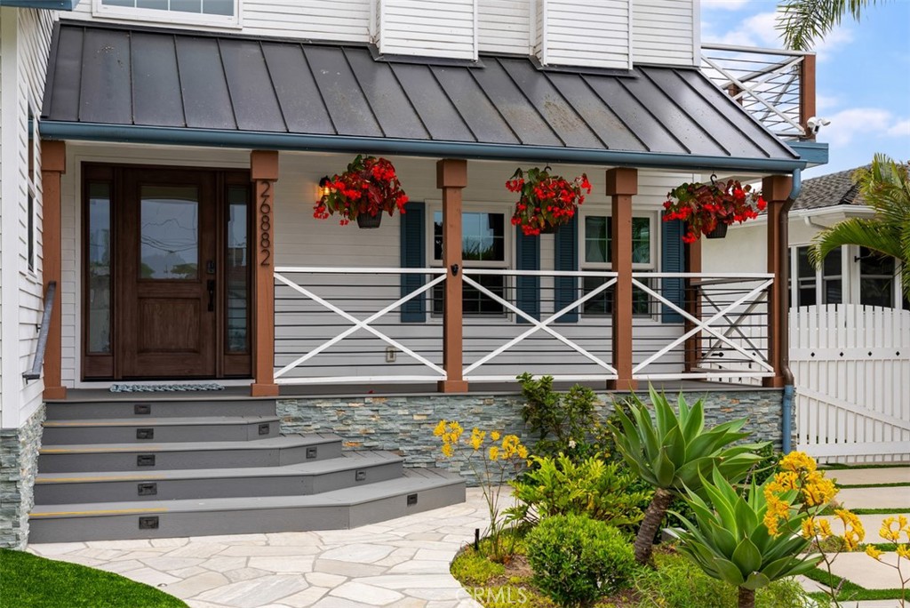 Large front porch, great for sitting and enjoying the ocean breezes that come with living so close to the coast. - 26882 Calle Real, Dana Point CA 92624 - photo 2
