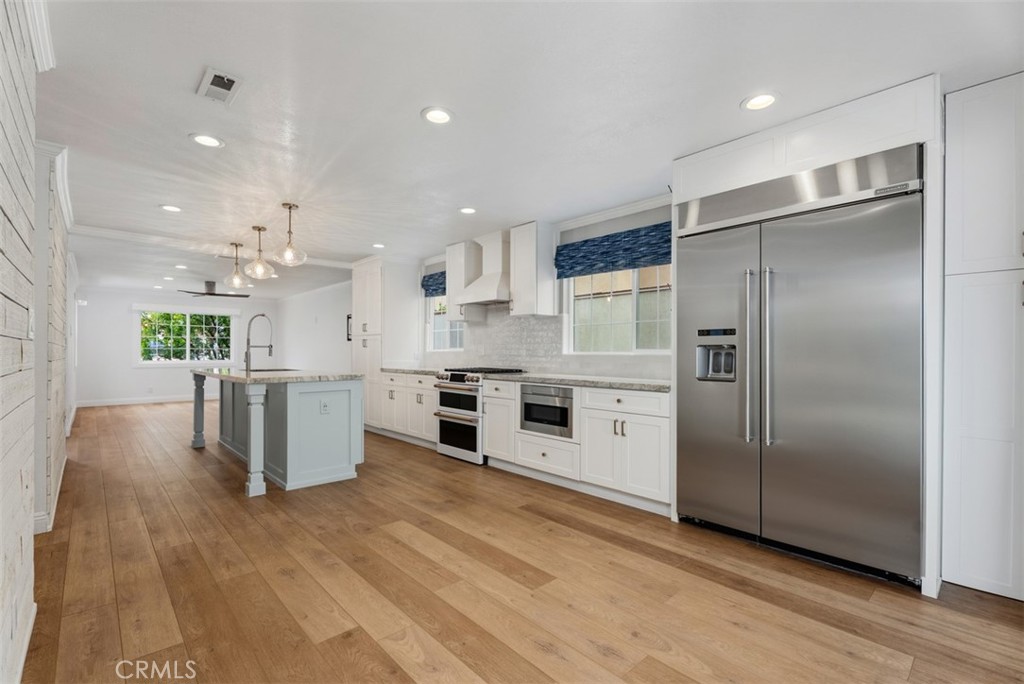 Kitchen opens one side to dining and family room on the other side. Centered by a spacious island with seating for 4. Lo - 26882 Calle Real, Dana Point CA 92624 - photo 8