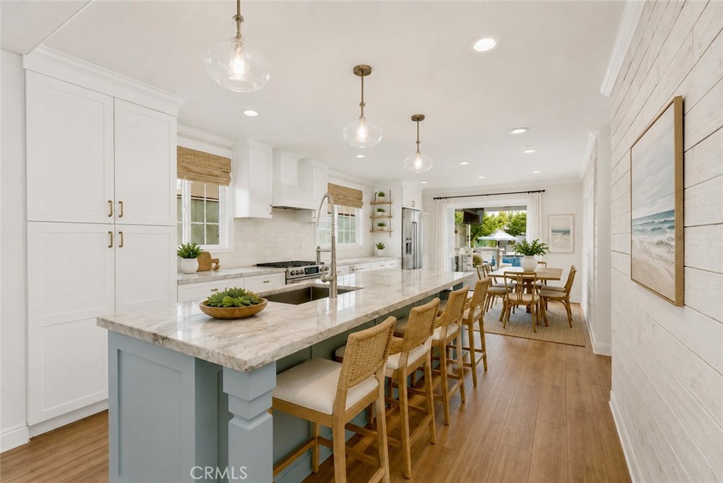 Kitchen island with seating for 4. AI Staged - 26882 Calle Real, Dana Point CA 92624 - photo 11