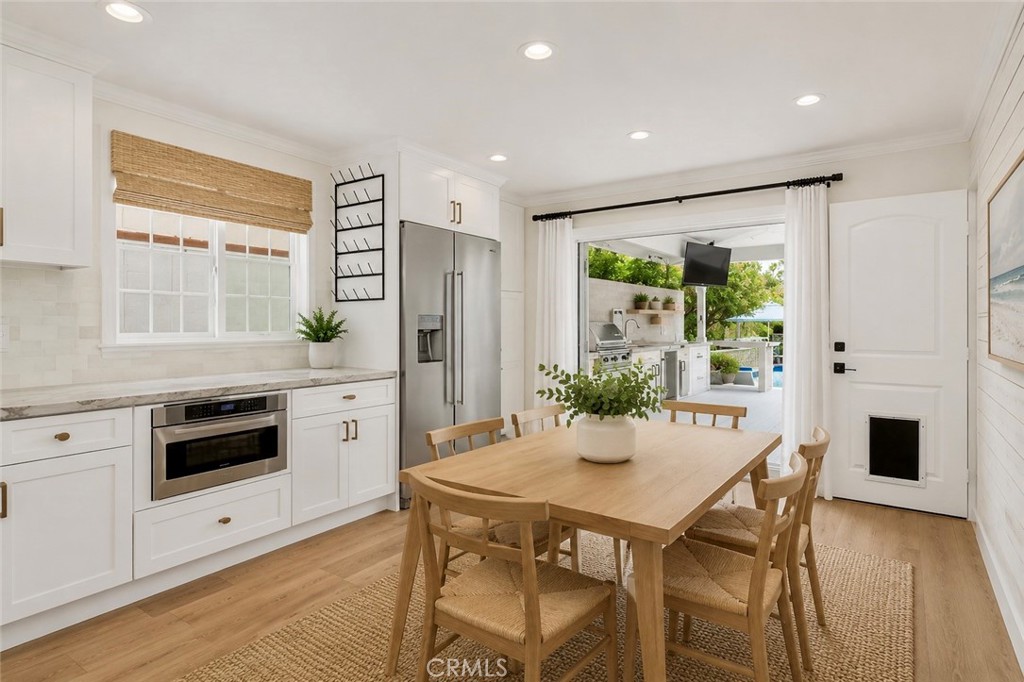 Kitchen extends to outdoor living space. AI Staged - 26882 Calle Real, Dana Point CA 92624 - photo 13