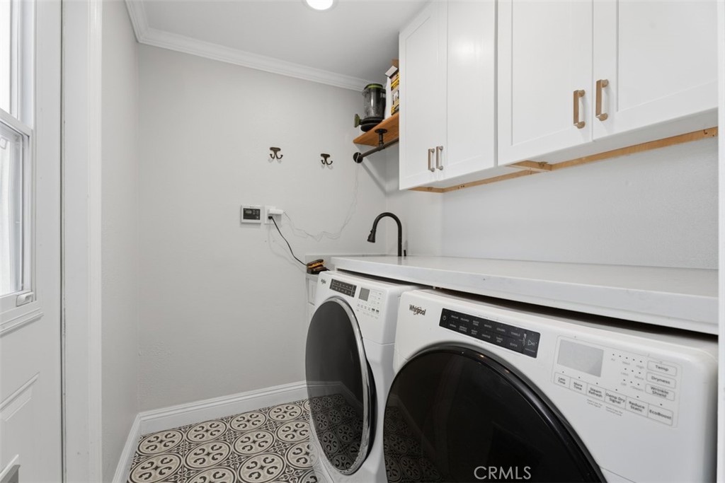 Laundry Room with sink and folding table. - 26882 Calle Real, Dana Point CA 92624 - photo 17
