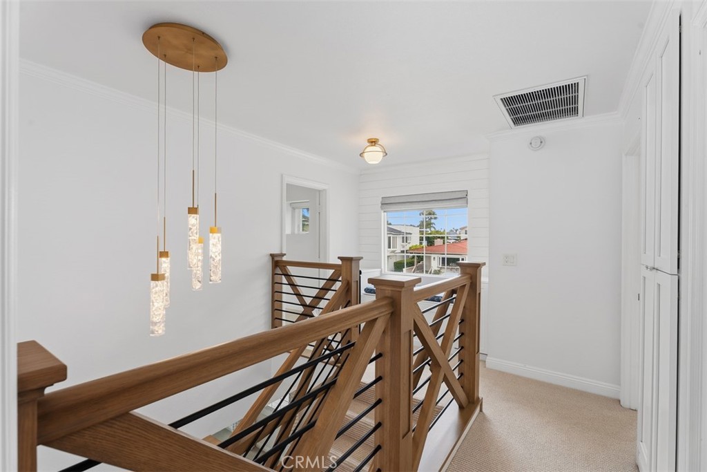 Upstairs landing with a window seat and additional storage, plus linen closet with adjustable shelves, just outside the - 26882 Calle Real, Dana Point CA 92624 - photo 21
